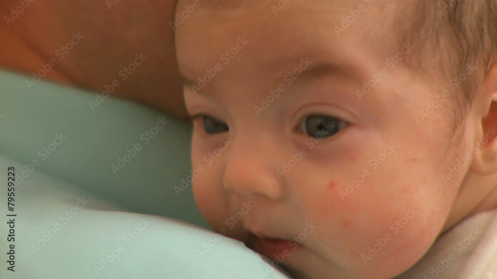 A two month old infant and it's father. A two month old infant and it's father.