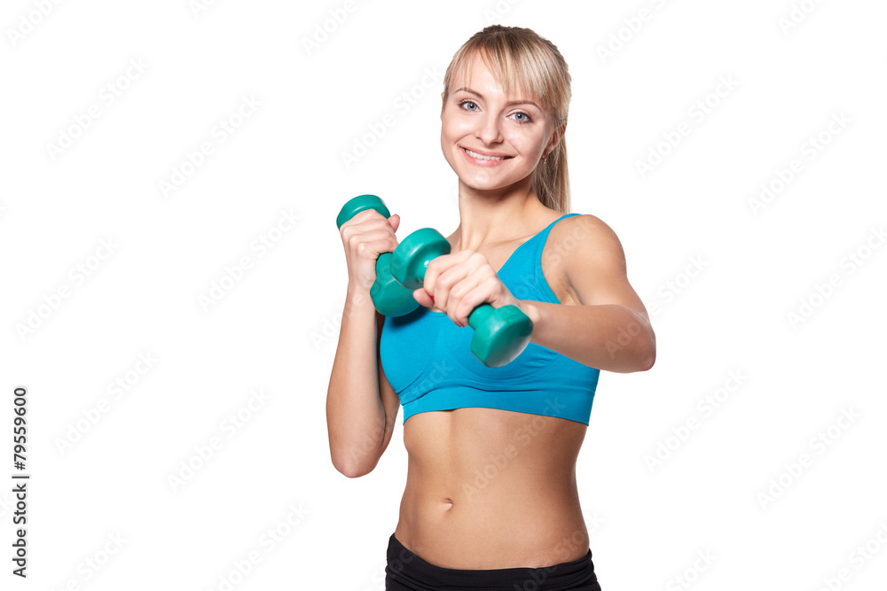 Young woman smiling while using dumbbells against a white backgr Young woman smiling while using dumbbells against a white backgr