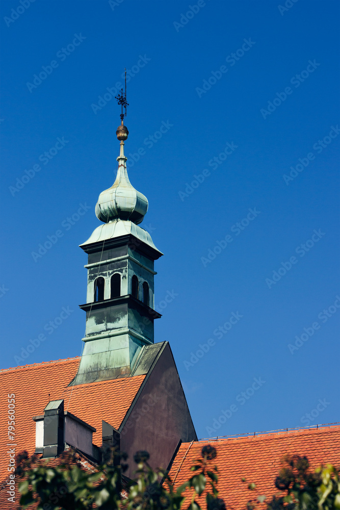 Old green church tower and some rooftops in Zagreb Croatia