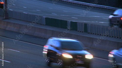 Light rush hour traffci of cars and trucks travel along a major U.S. roadway. photo