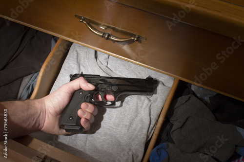 hand reaching for hand gun