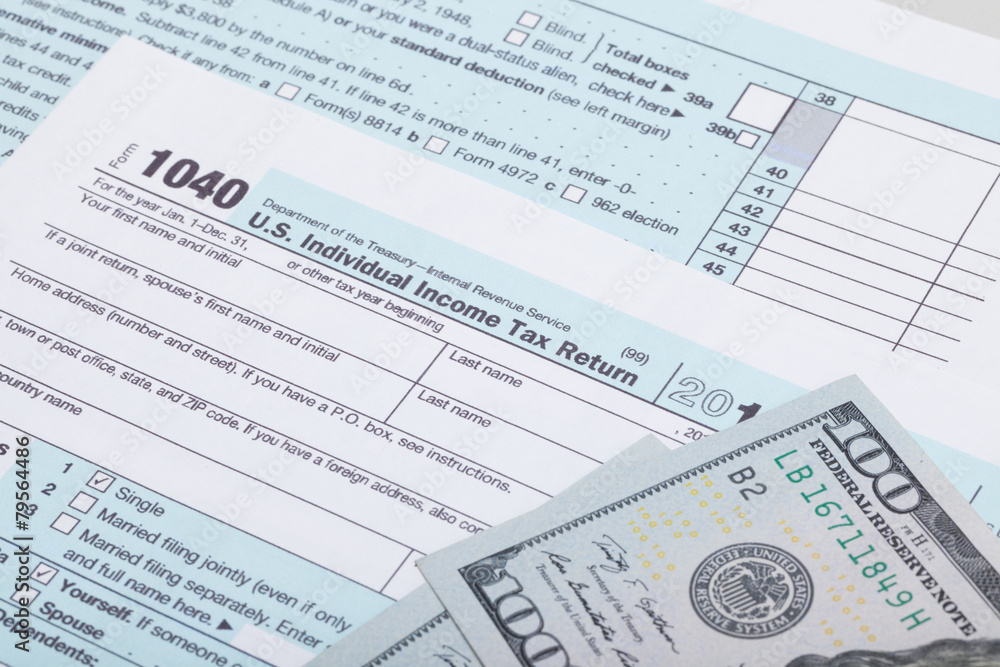 US 1040 Tax Form and dollars - studio shot US 1040 Tax Form and dollars - studio shot