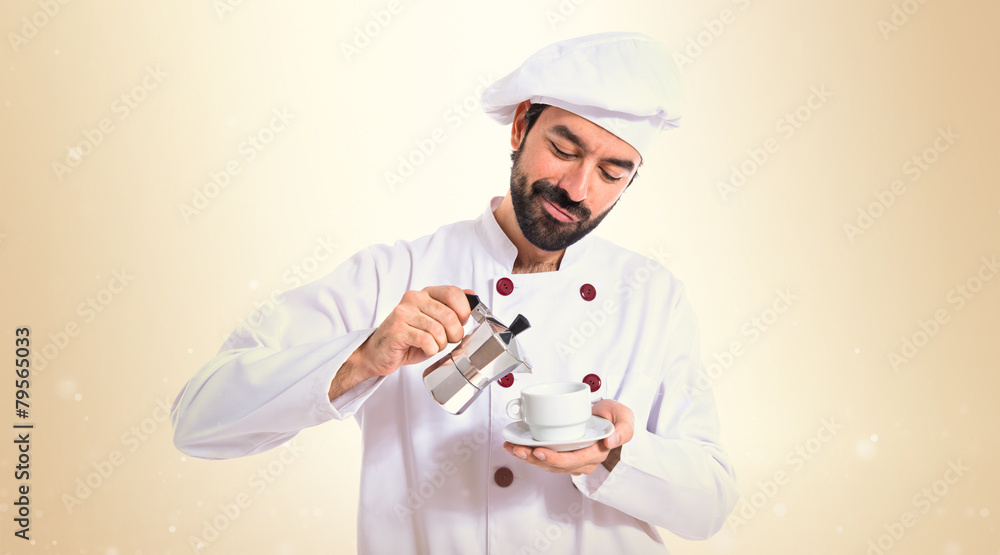 Chef holding a cup of coffee over white background Chef holding a cup of coffee over white background