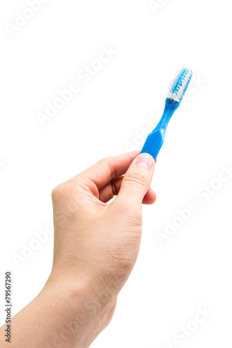 hand holding old toothbrush