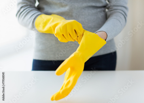 close up of woman wearing protective rubber gloves
