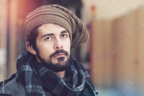 portrait of young hipster bearded man warm tones filter applied