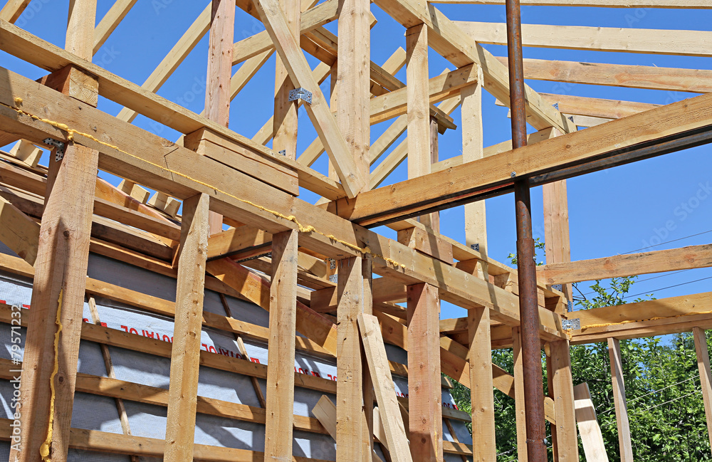 Installation of wooden beams at construction Installation of wooden beams at construction