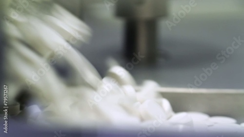 Many pills at a pharmaceutical factory are shot closeup