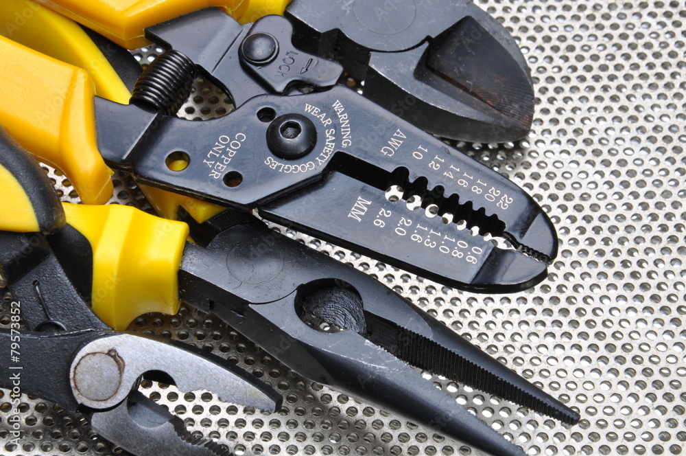 Fototapeta premium Tools for electrical installation on metal surface