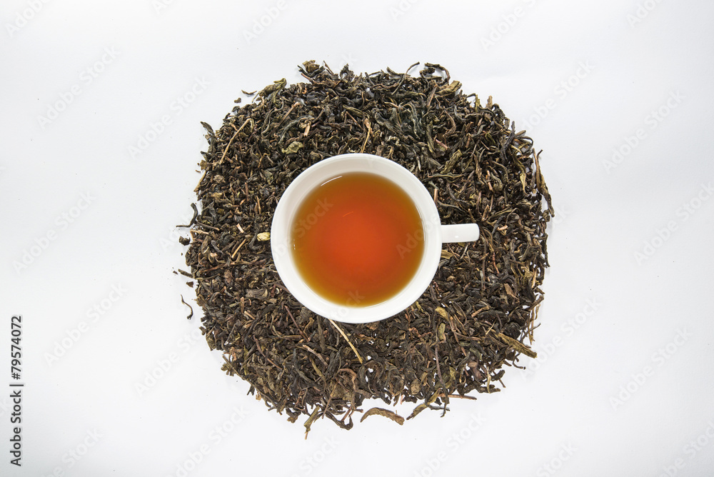 Dried tea leaf and the white cup of tea Dried tea leaf and the white cup of tea