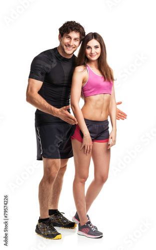 Sport couple - man and woman after fitness exercise on the white