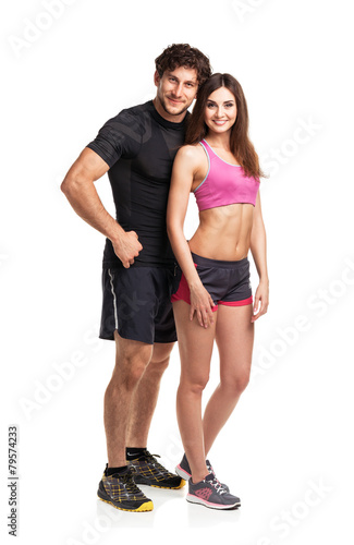 Sport couple - man and woman after fitness exercise on the white