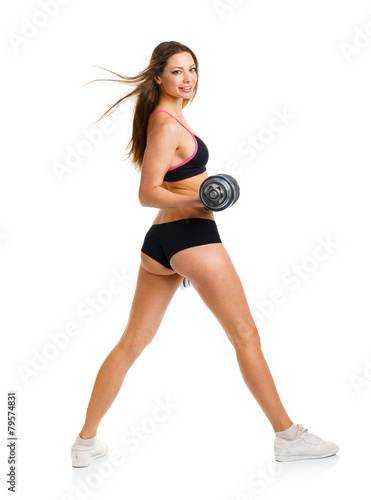 Beautiful athletic woman with dumbbells doing sport exercise, is