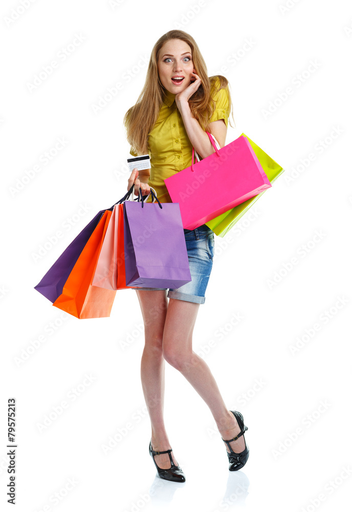 Happy caucasian woman with shopping bags and holding credit card