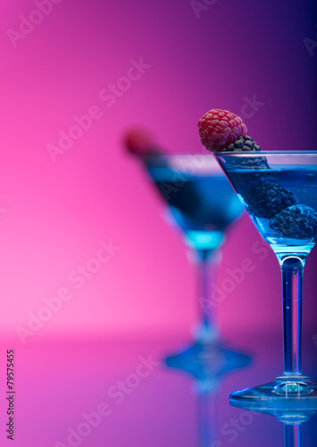 Colourful cocktails garnished with berries photo