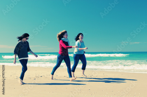 Three best friends walking at seaside