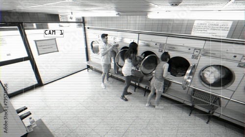 High Angle LS CCTV Style Three Young Adults use the Launderette 