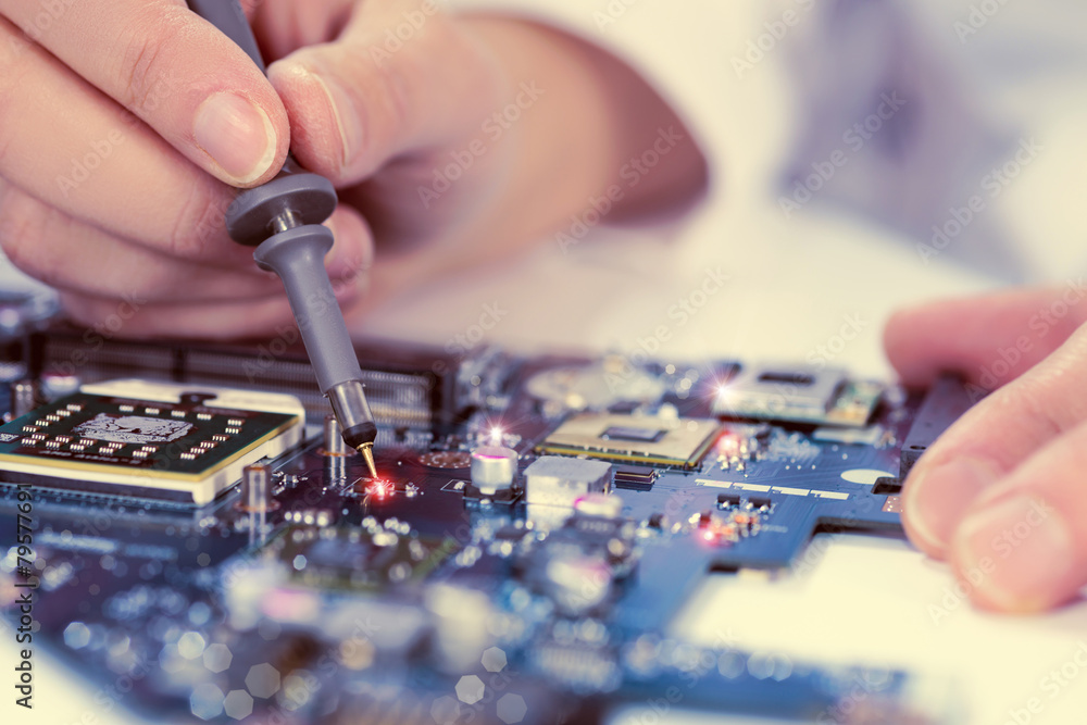 Technological background with closeup on tester checking motherb Technological background with closeup on tester checking motherb