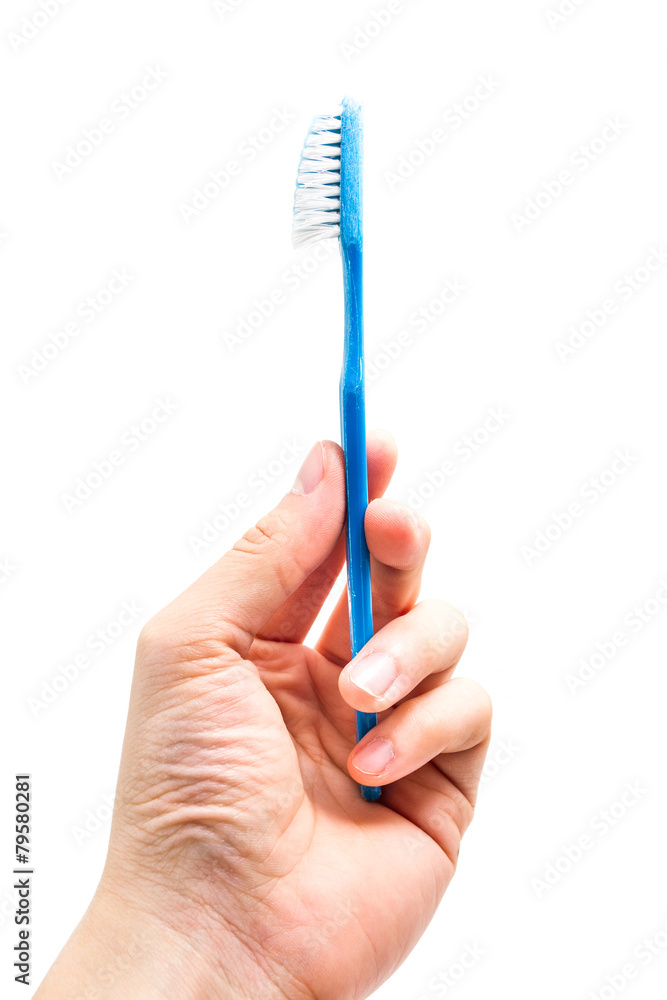 hand holding old toothbrush hand holding old toothbrush