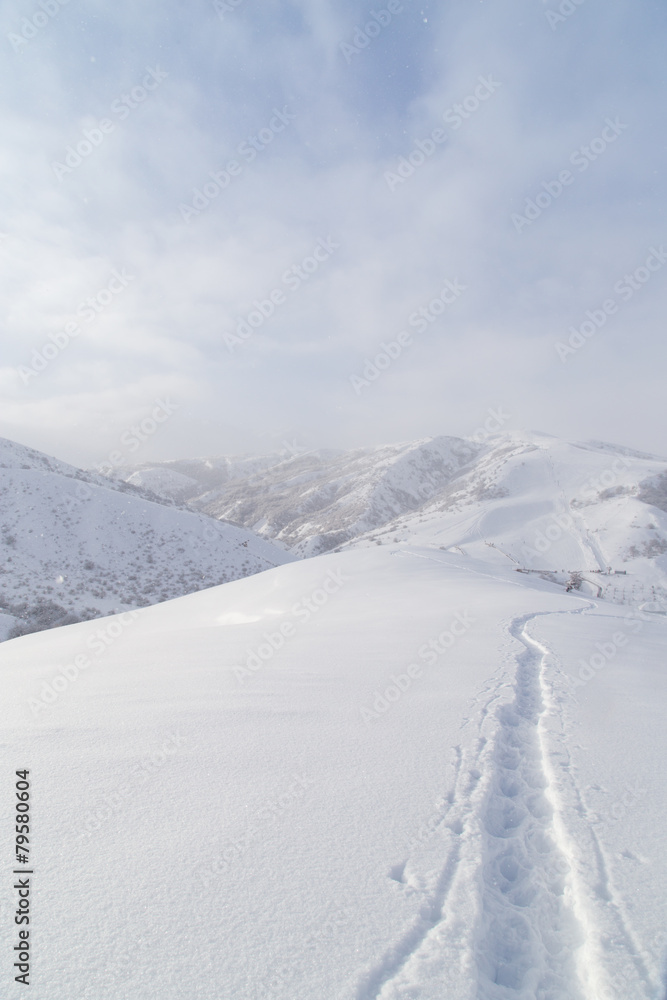 Trail in the snow in the mountains Trail in the snow in the mountains
