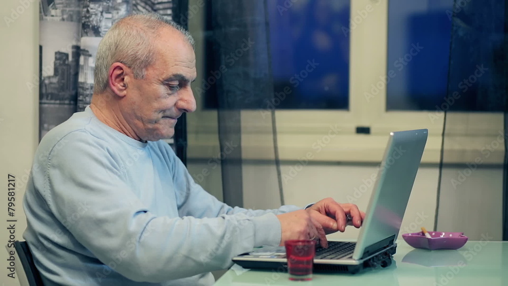 Older man studying computer and takes coffee Older man studying computer and takes coffee