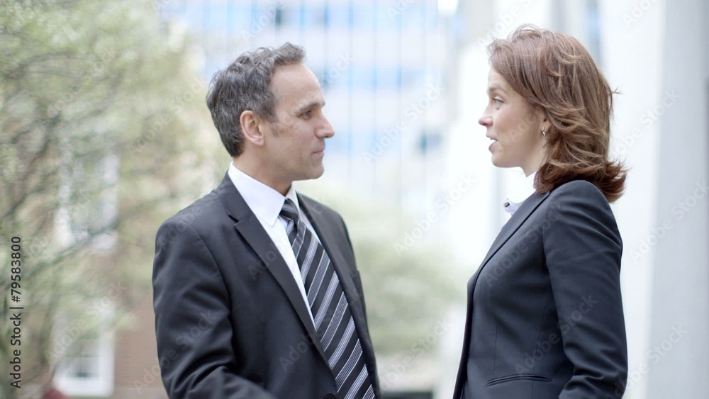 Business Man and Business Woman meet and greet each other, before heading off to their meeting Business Man and Business Woman meet and greet each other, before heading off to their meeting