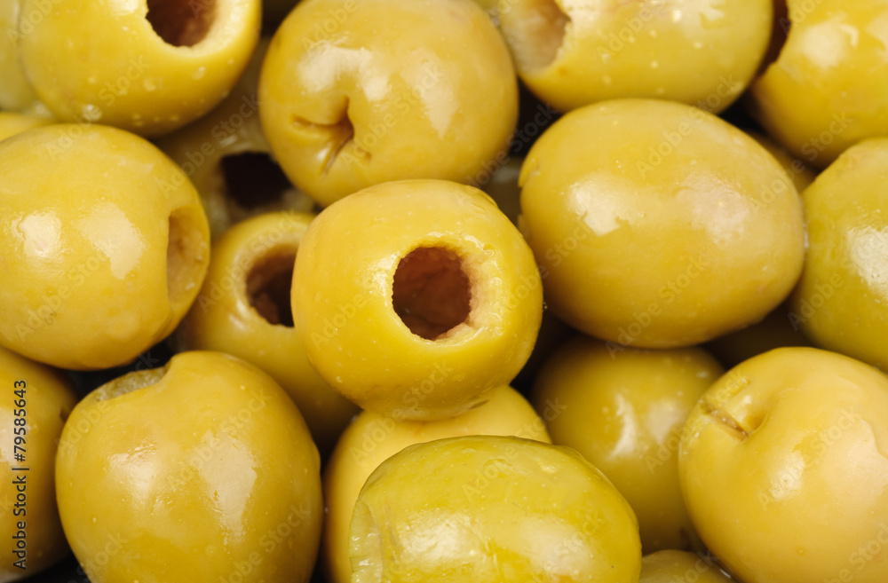Abstract background: green pitted olives. Abstract background: green pitted olives.