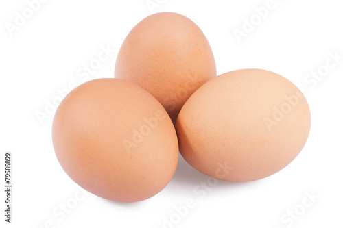 Three chicken eggs on a white background