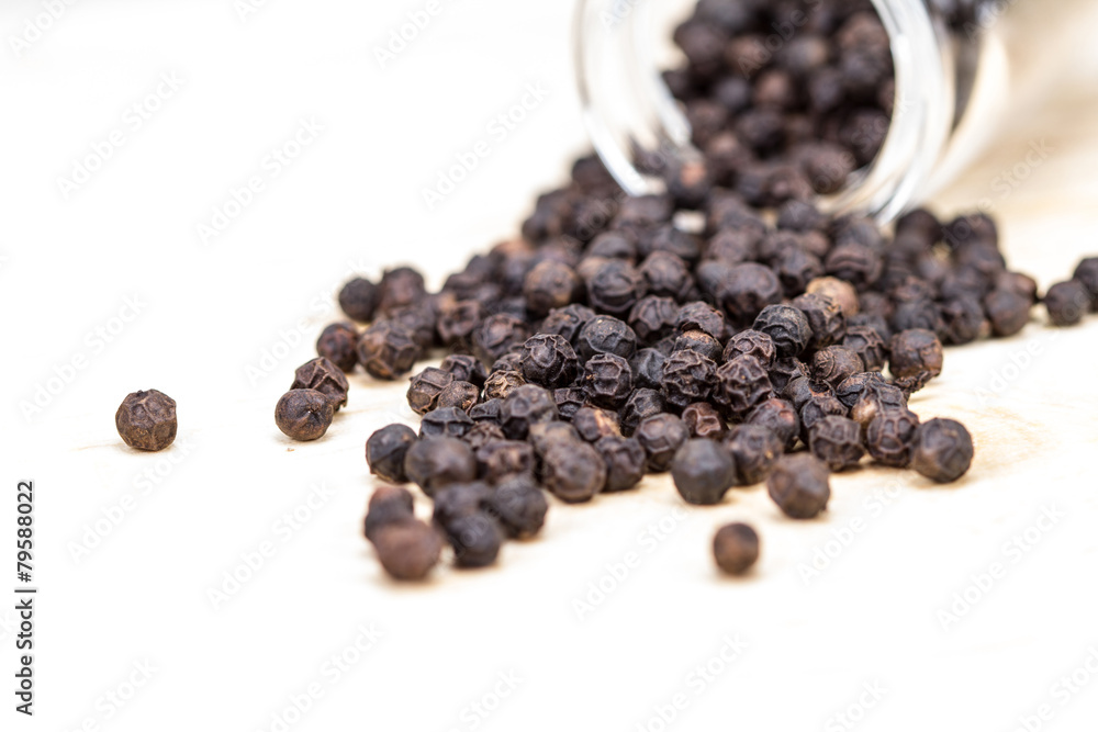 closeup dried black pepper on white background closeup dried black pepper on white background