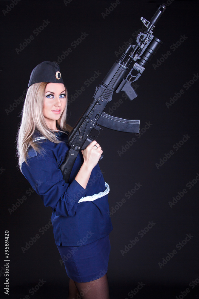 Beautiful young woman in a marine uniform with an assault rifle Beautiful young woman in a marine uniform with an assault rifle