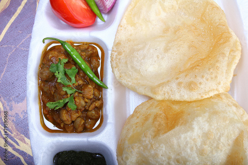 indian spicy dish, chole bhature topping of green chili photo