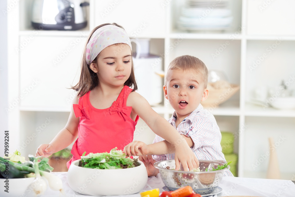 Children in the kitchen preparing salad