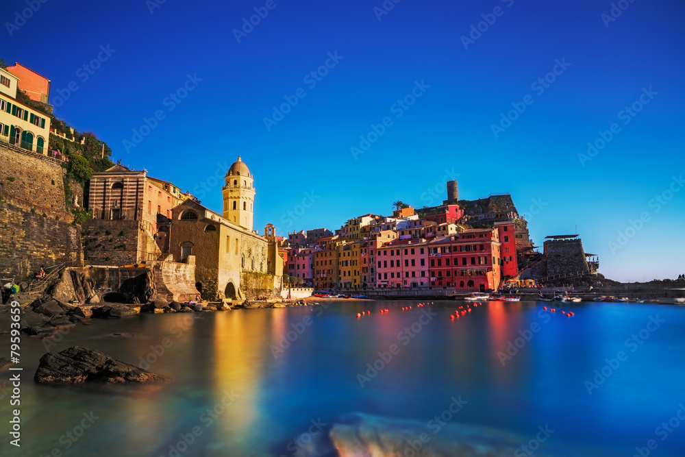 Fototapeta premium Vernazza village, church, rocks and sea harbor on sunset. Cinque