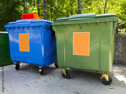 New colorful plastic garbage containers in park © alexrow