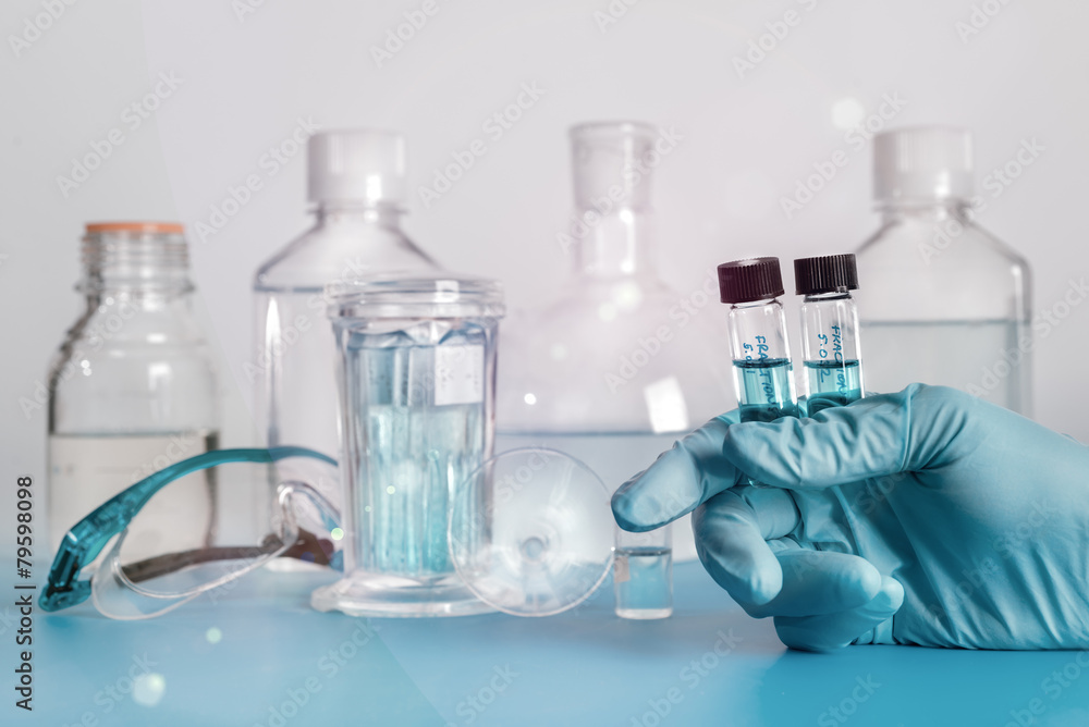 Two liquid samples in plastic vials in gloved hand Two liquid samples in plastic vials in gloved hand