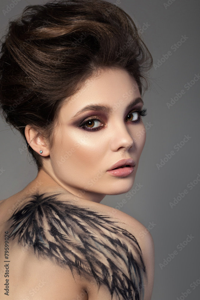 Portrait of young sensual brunette woman with black wing Portrait of young sensual brunette woman with black wing