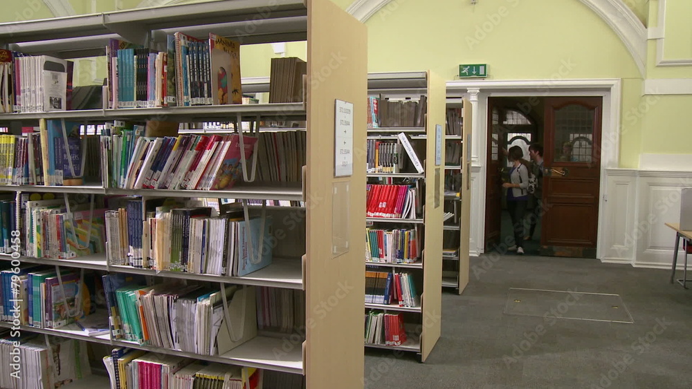 Students walking into library and researching Students walking into library and researching
