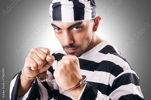 Convict criminal in striped uniform photo