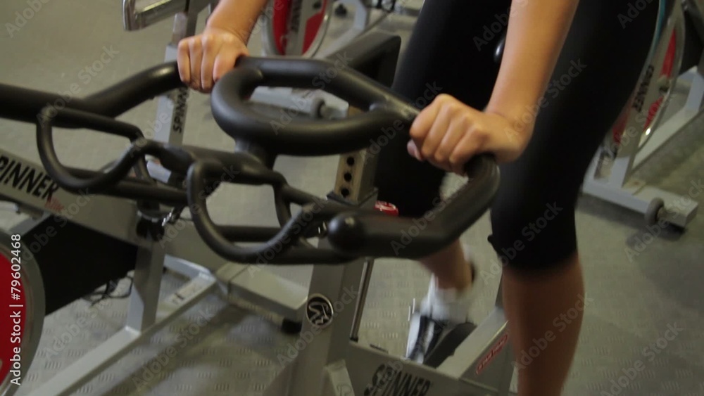 Group working out on bicycles in a gym Group working out on bicycles in a gym