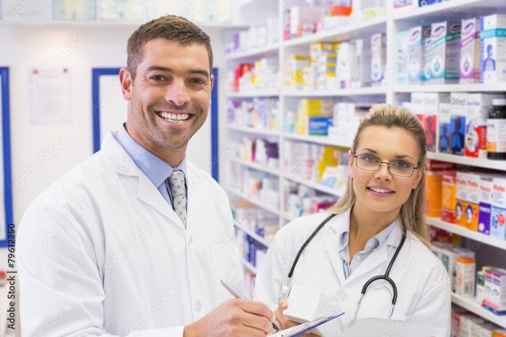 Team of pharmacists smiling at camera Team of pharmacists smiling at camera