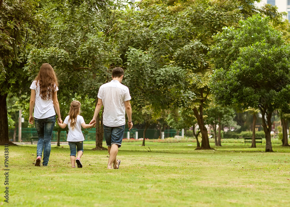 Family walk in the park, happy at sunset in Bangkok, Thailand. Family walk in the park, happy at sunset in Bangkok, Thailand.