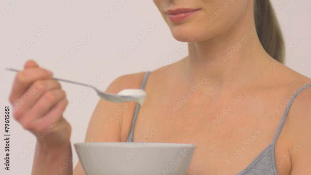 MCU PAN OF A WOMAN EATING YOGHURT MCU PAN OF A WOMAN EATING YOGHURT