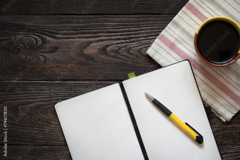 Notebook, pen and coffee pot on the table Notebook, pen and coffee pot on the table