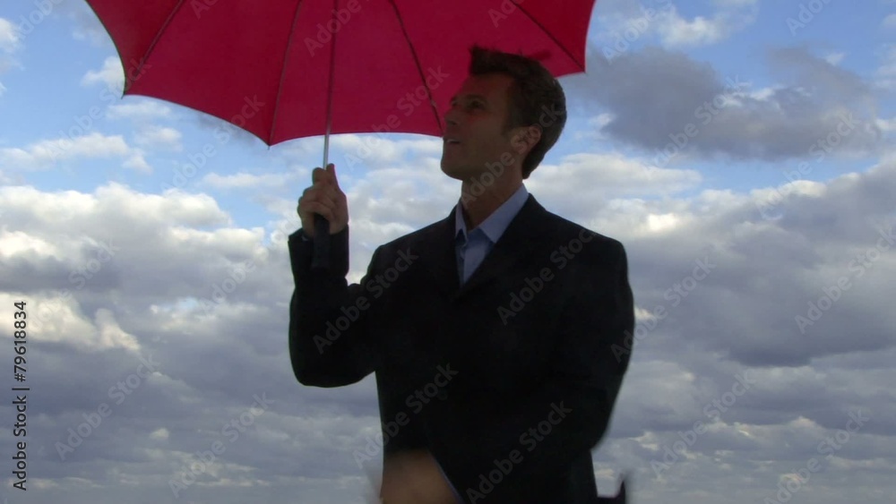 Cu of a male opening an umbrella on a beach and checking if it is raining Cu of a male opening an umbrella on a beach and checking if it is raining