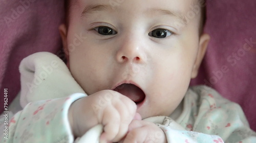 Close-up of baby girl's face who is babbling