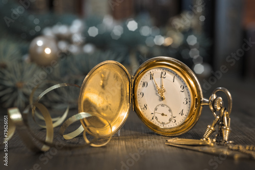 Vintage watch on a festive background showing five to midnight