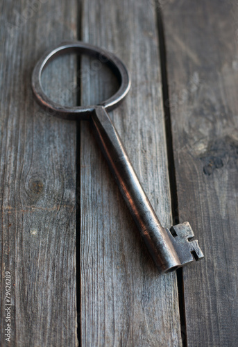 big key on wooden rustic table © blue_caterpillar