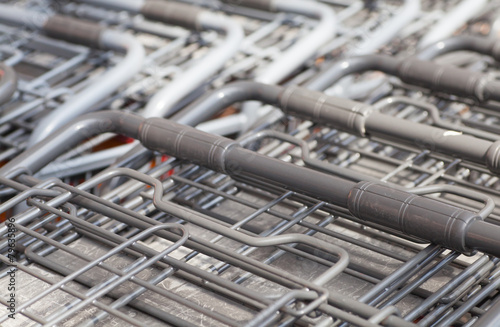 Rows of shopping carts at supermarket entrance