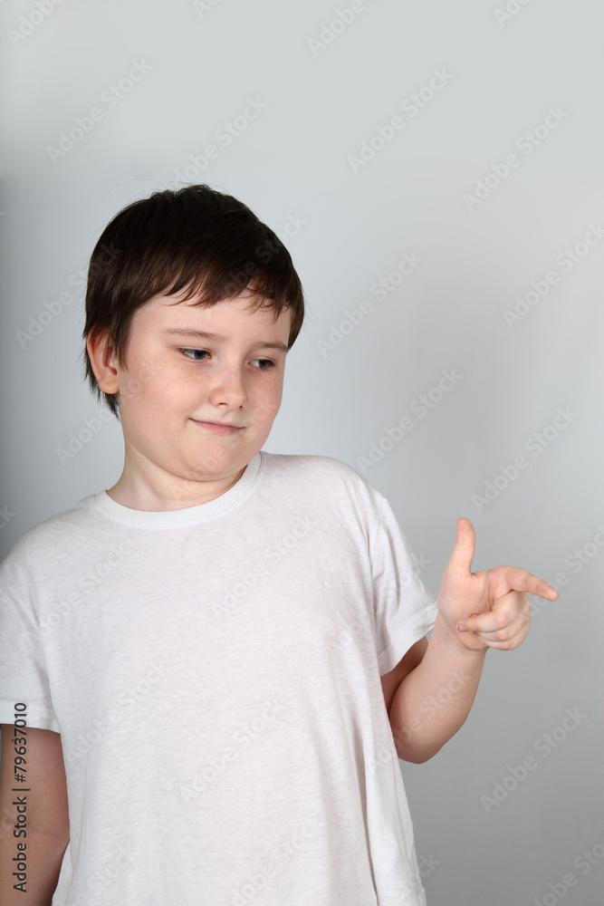 Boy shows his finger to the side Boy shows his finger to the side