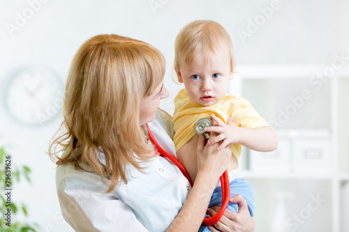 pediatrician examining hear...